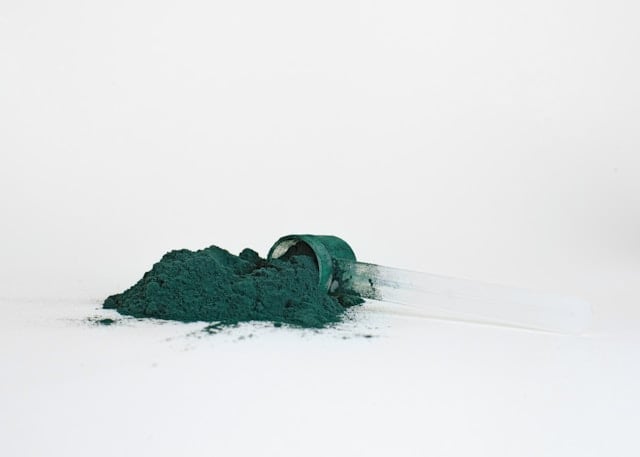 Reviewing Andrew Huberman's Supplement Routine in 2025 5 Athletic greens powder on a white table