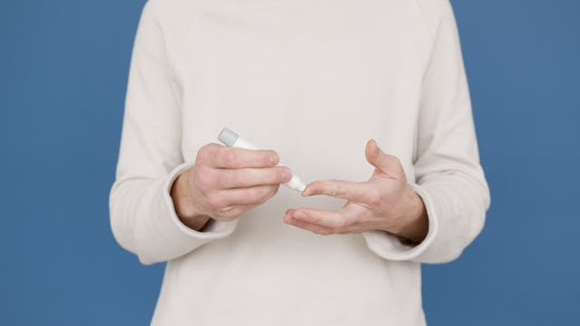 How to Test Your NAD Levels: A Complete Guide 5 Woman using a finger prick blood sample collection device