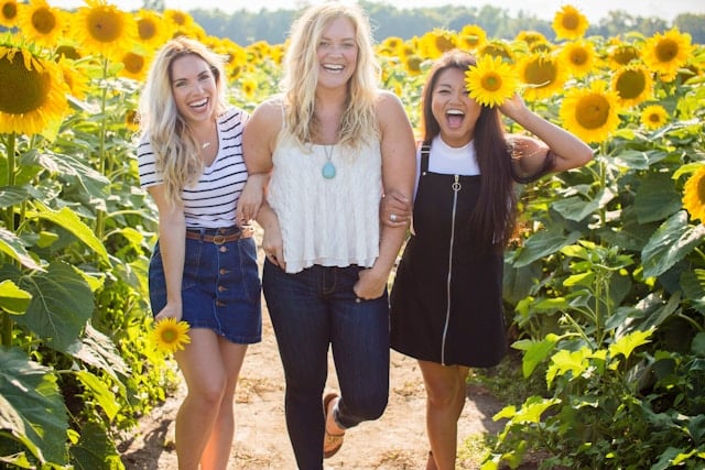 Should Women Take NAD+ Supplements? 4 Three smiling women in a sunflower field