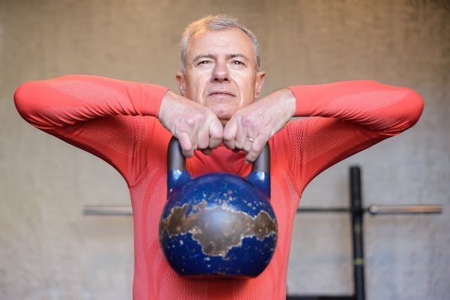 Why NAD+ Matters for Bodybuilding and Muscle Growth 5 An older man lifting a kettlebell in the gym