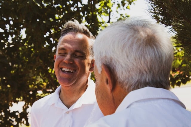 NAD+ vs. NADH: Key Differences and Which is Better 9 Two men having a joyful conversation outdoors