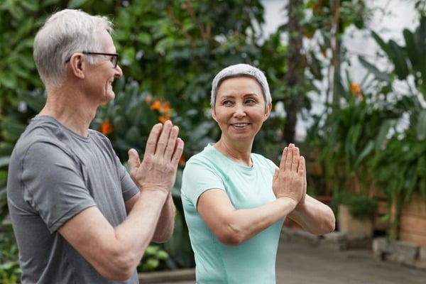 NAD Deficiency Symptoms: 6 Common Signs of Low NAD Levels 9 An image of a man and woman exercising