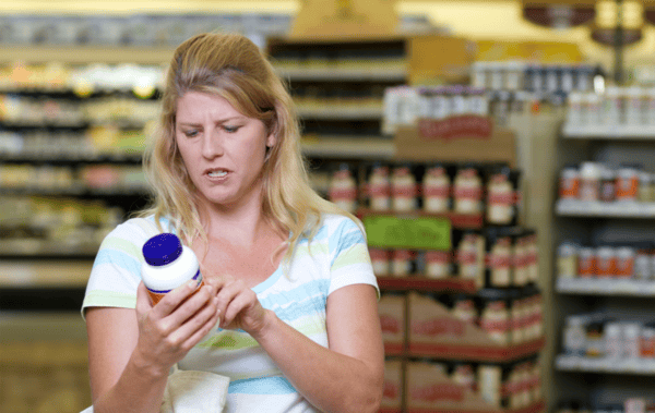 Choosing a High Quality Turmeric Supplement: Buyer's Guide 5 a woman holding a bottle of medicine