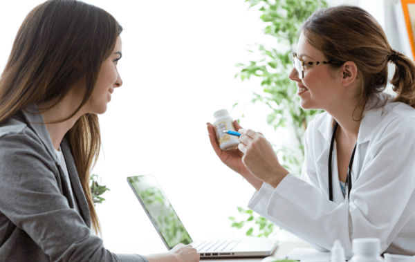 Choosing a High Quality Turmeric Supplement: Buyer's Guide 6 a woman holding a bottle of pills