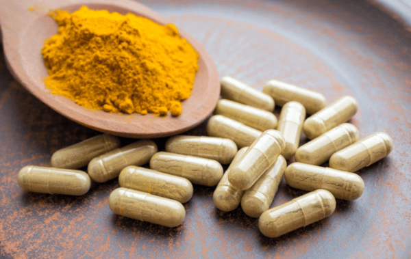 Choosing a High Quality Turmeric Supplement: Buyer's Guide 7 a spoon full of pills and powder