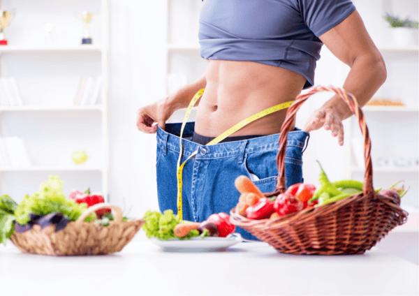 Can NAD Supplements Help You Lose Weight? 4 a man with a measuring tape measuring his waist