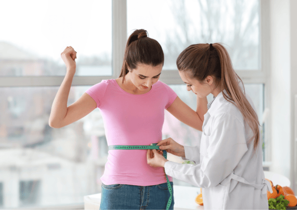 Can NAD Supplements Help You Lose Weight? 10 a woman measuring her waist with a measuring tape