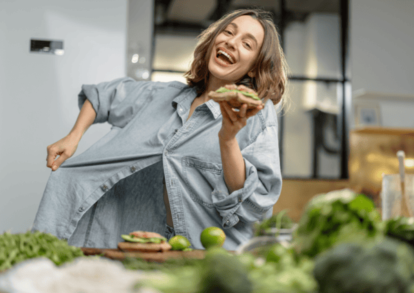 Can NAD Supplements Help You Lose Weight? 12 a woman smiling and holding a sandwich