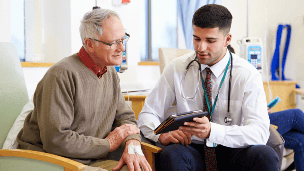 What's the Difference Between NMN vs NAD? 12 An image of an older man consulting with his doctor