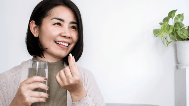 The Regenerative Benefits of NAD+ for Aging Skin 7 An image of a woman taking supplement