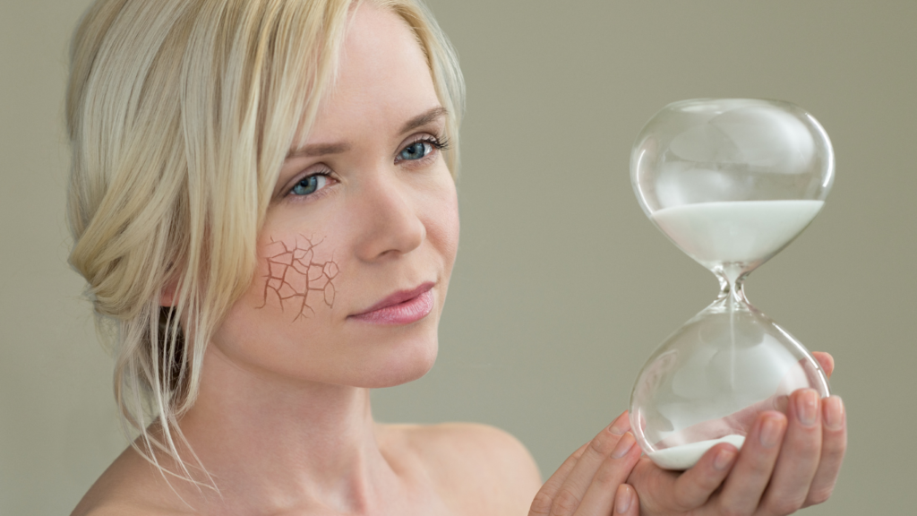 What are Epigenetic Clocks? Why These "Aging Clocks" Matter 6 An image of an aging woman looking at an hourglass depicting aging.