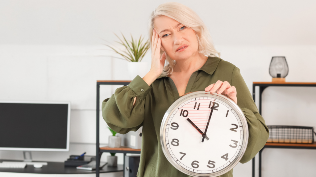 What are Epigenetic Clocks? Why These "Aging Clocks" Matter 7 An image of an uncomfortable woman holding a clock depicting aging.