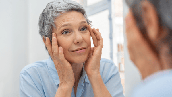 7 Anti-Aging Exercises for Longevity (and One Workout to Avoid) 11 An image of a matured woman doing facial exercise.