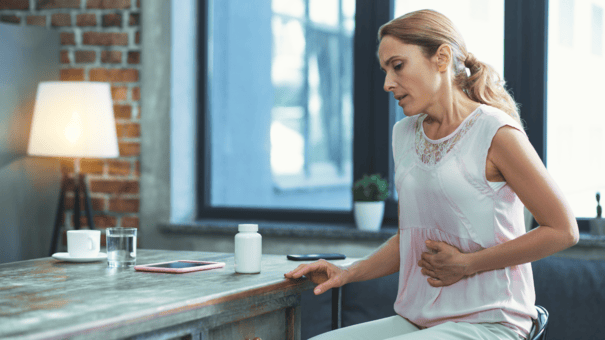 NMN vs. Niacin: Safety and Efficacy for Longevity 5 An image of a matured woman suffering from the side effects of NMN and Niacin.