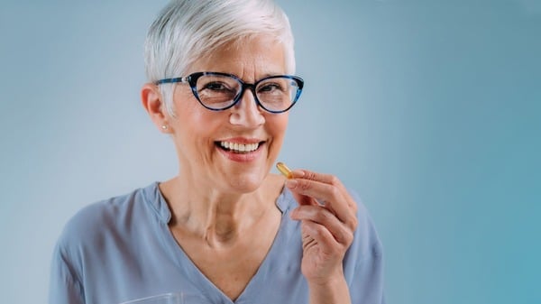 Why Take Quercetin with Bromelain? 7 Health Benefits to Know 7 An image of a woman taking supplements