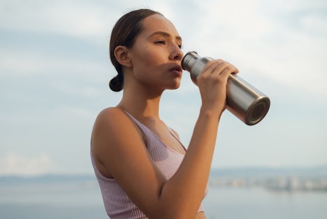 Nicotinamide Riboside vs. Niacinamide: Which is Better? 7 Fit Woman Drinking from Thermos