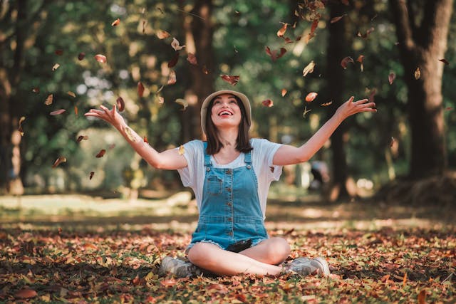 Chronic Fatigue Supplements: What Science Actually Says 7 A photo of a woman with high energy playing in the autumn leaves, having overcome her chronic fatigue