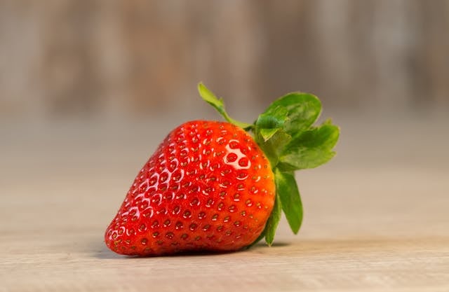 Quercetin vs. Fisetin: Differences and Combined Benefits 6 Strawberry fruit on brown wooden surface