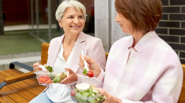 An image of two matured woman eating a healthy diet