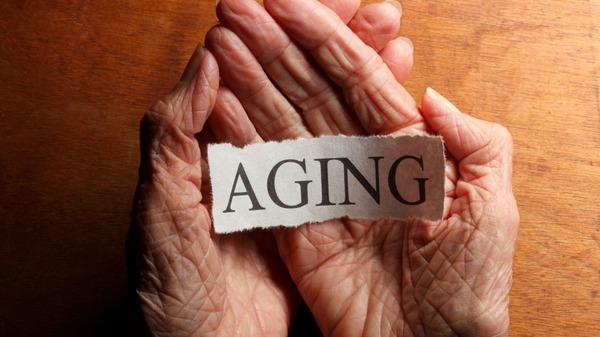 Cellular Senescence and Aging: Problems and Solutions 9 An elderly woman's hands holding a note that says "Aging"