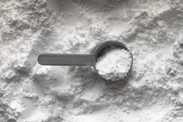 Creatine powder and scoop