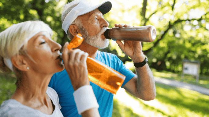 An image of a man and woman drinking water