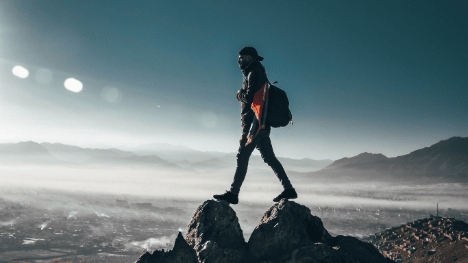 Is Creatine Worth It for Climbing Performance? 4 A daring climber at the top of a mountain