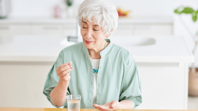 An image of a matured woman taking supplement