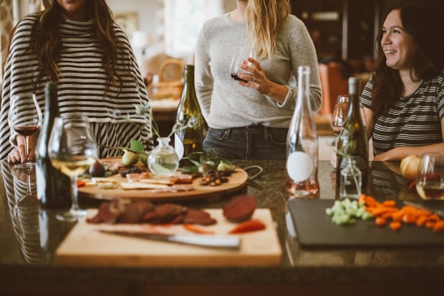 Premature Aging: Causes, Common Signs and Prevention Tips 8 A group of friends around a charcuterie board
