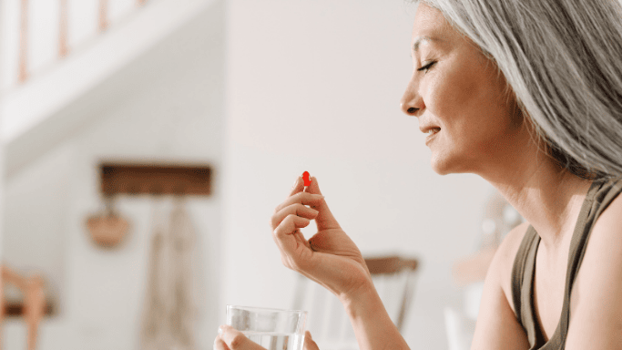 Can Creatine Help with Fibromyalgia Symptoms? 7 An image of a mature woman taking supplement