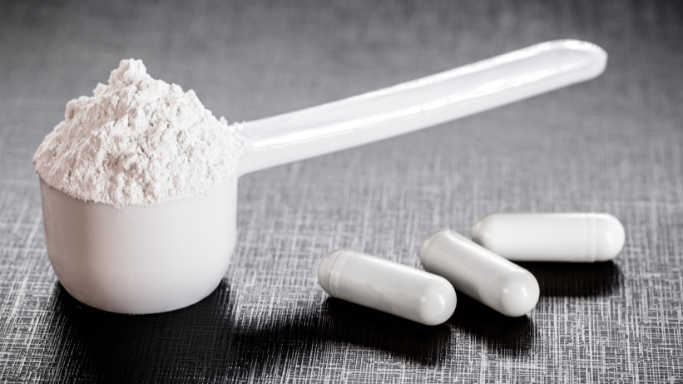 An image of a creatine powder and capsules