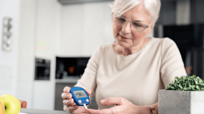 5 Anti-Inflammatory Health Benefits of Ginger Root 8 An older woman checking her blood sugar with a glucometer.