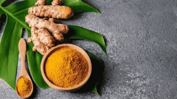 5 Anti-Inflammatory Health Benefits of Ginger Root 10 An image of turmeric and turmeric powder in a bowl