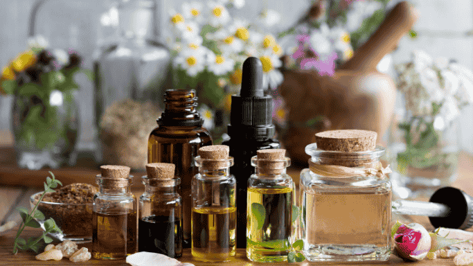 An image showing Bottles of essential oils arranged on a surface.