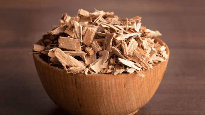 An image showing willow bark placed in a wooden bowl.