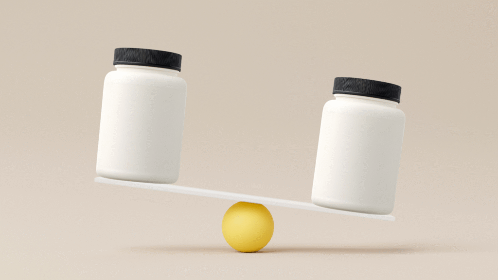 Creatine Nitrate vs Monohydrate: What Science Actually Says 10 Two identical white jars with black lids are placed on opposite ends of a white seesaw balanced on a yellow sphere, with the left side tilted downward.