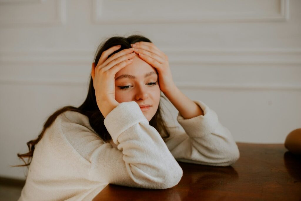 Exhausted woman holding her head