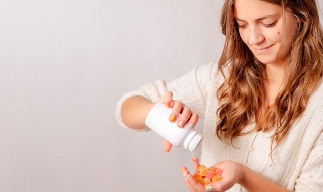 NAD Injections vs. Oral NAD Supplements: How Do They Compare? 6 woman holding creatine gummies a89e75f8