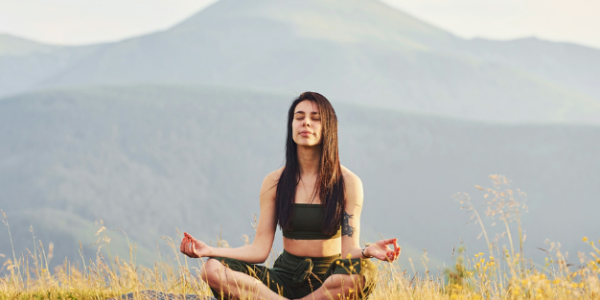Homepage 36 A woman meditating in a field
