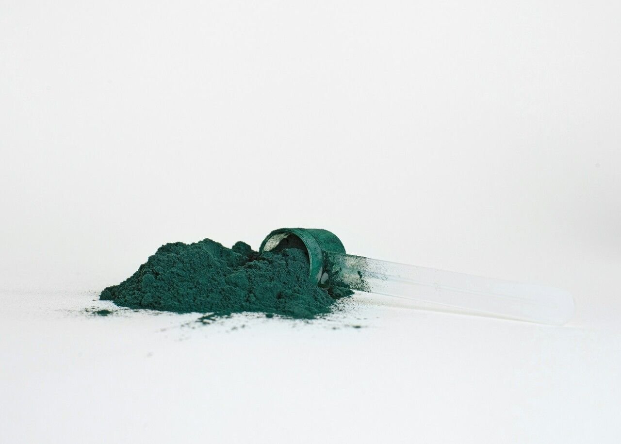 Athletic greens powder on a white table