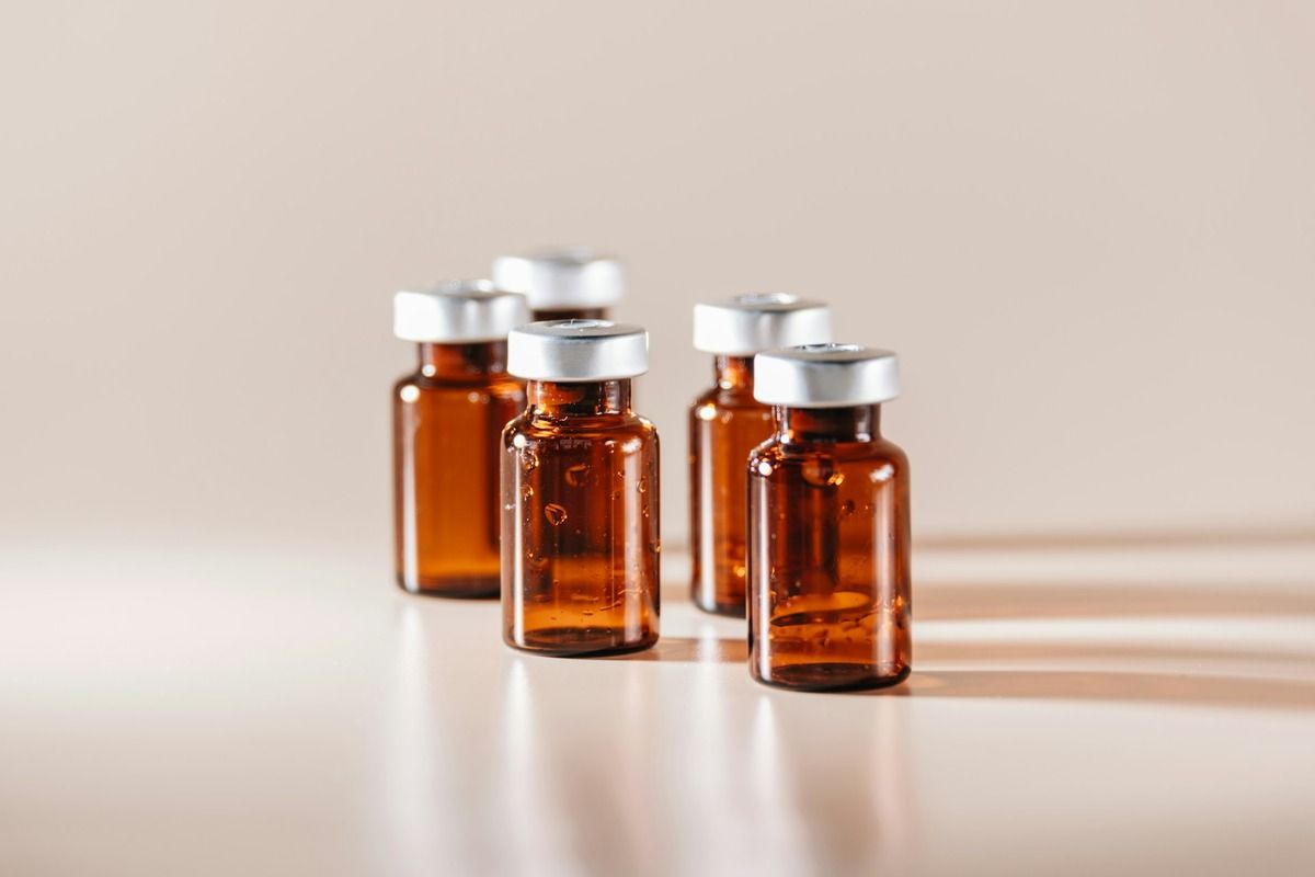 NAD vs peptides featured image showing peptide vials on a counter in dramatic lighting