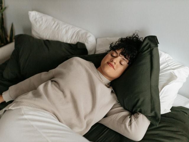 A woman takes a nap during an afternoon slump.