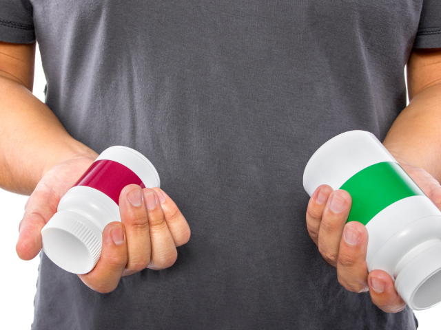 What's the Difference Between NAD, NADP and NADPH? 4 Man holding two supplement bottles