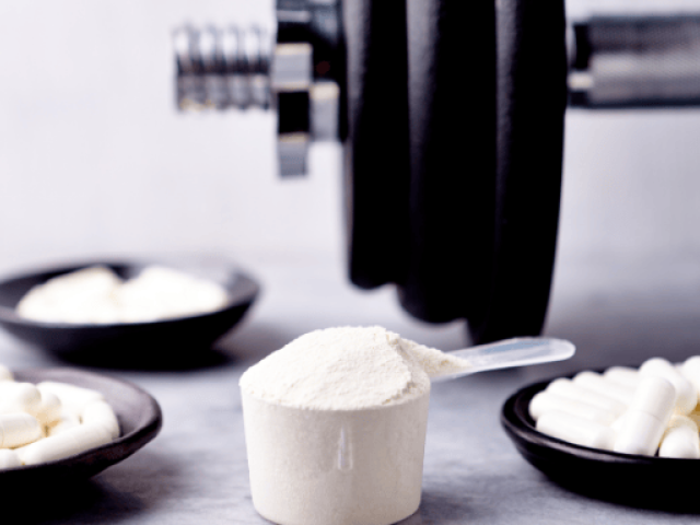 Creatine Starter Guide: Loading, Timing & Beginner Tips 4 An image of creatine and a barbell on the background