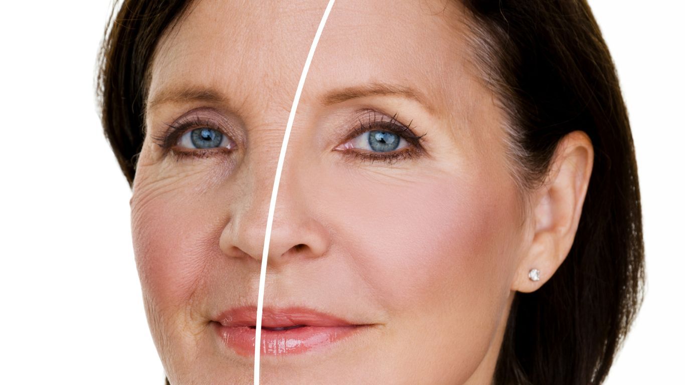 An image of a woman with one half of her face youthful and the other half aged.