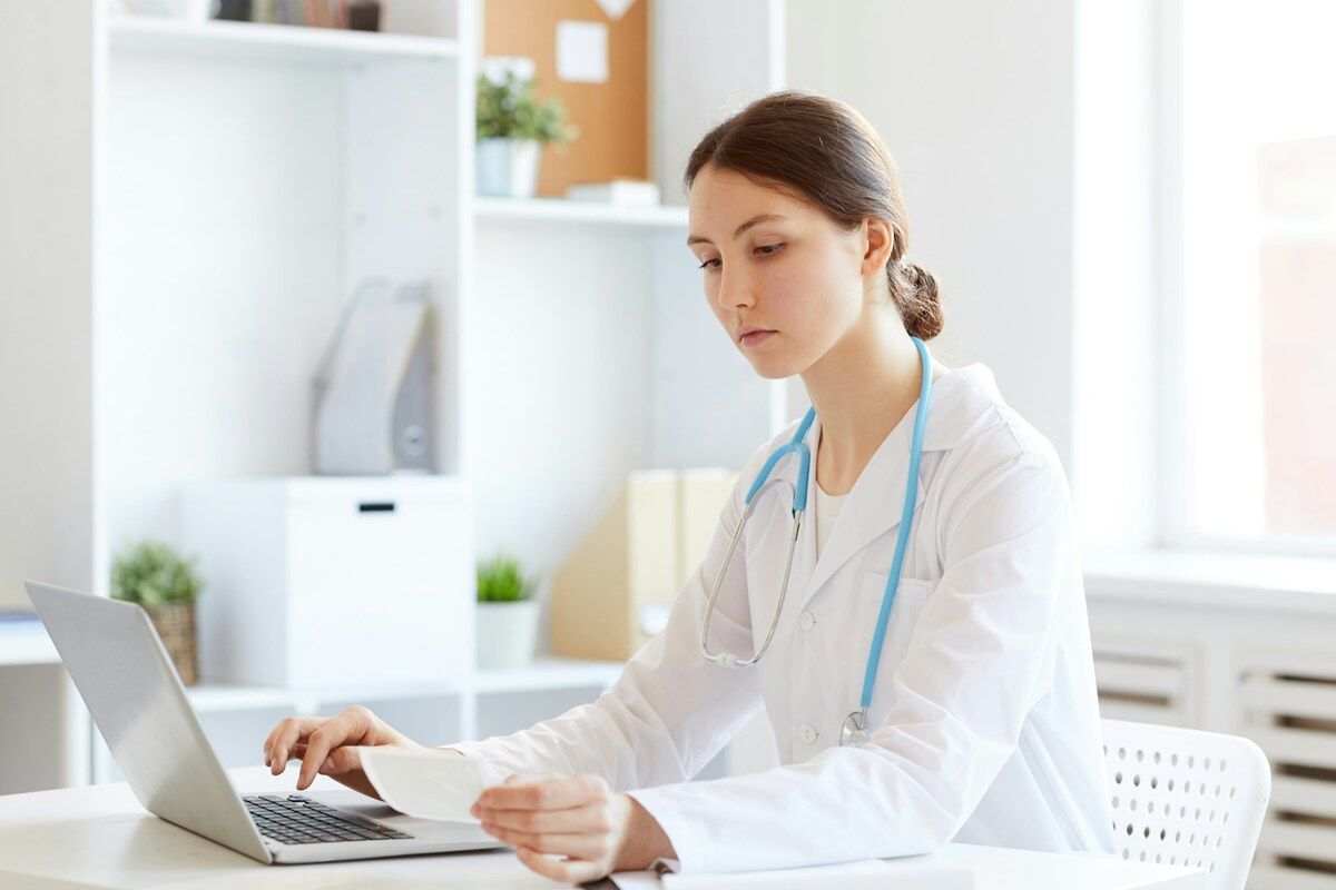 A doctor examines her patient's vitamin B3 test results.