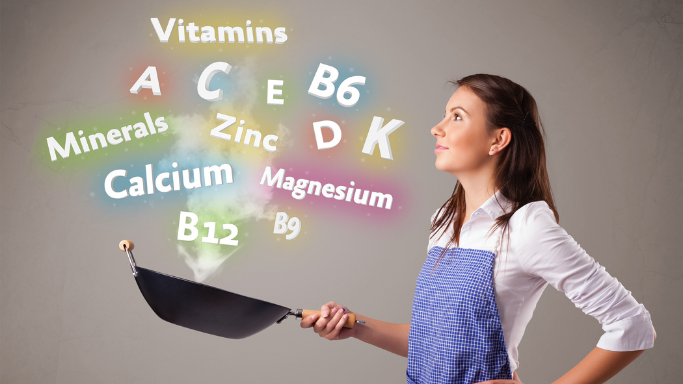 Woman holding a frying pan with colorful text representing essential anti-aging nutrients like vitamins A, C, D, E, B6, B12, and minerals such as calcium, magnesium, and zinc for aging well.