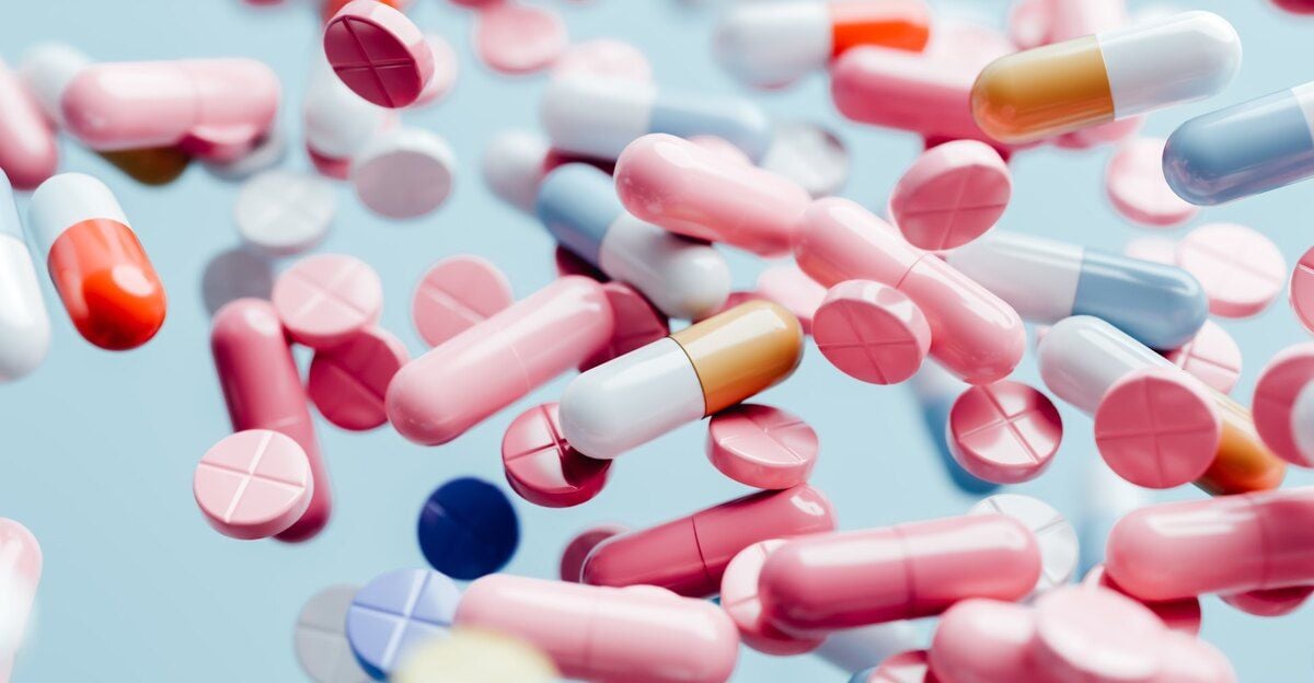 NAD dosage featured image - NAD supplements falling against blue background