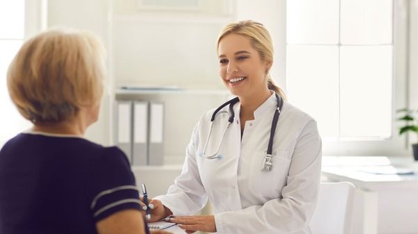 An image of a doctor and an old woman discussing about mitochondrial decline