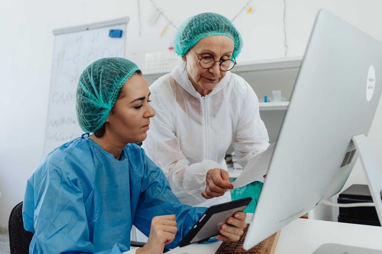Two medical doctors analyzing a patient's biomarkers on a computer